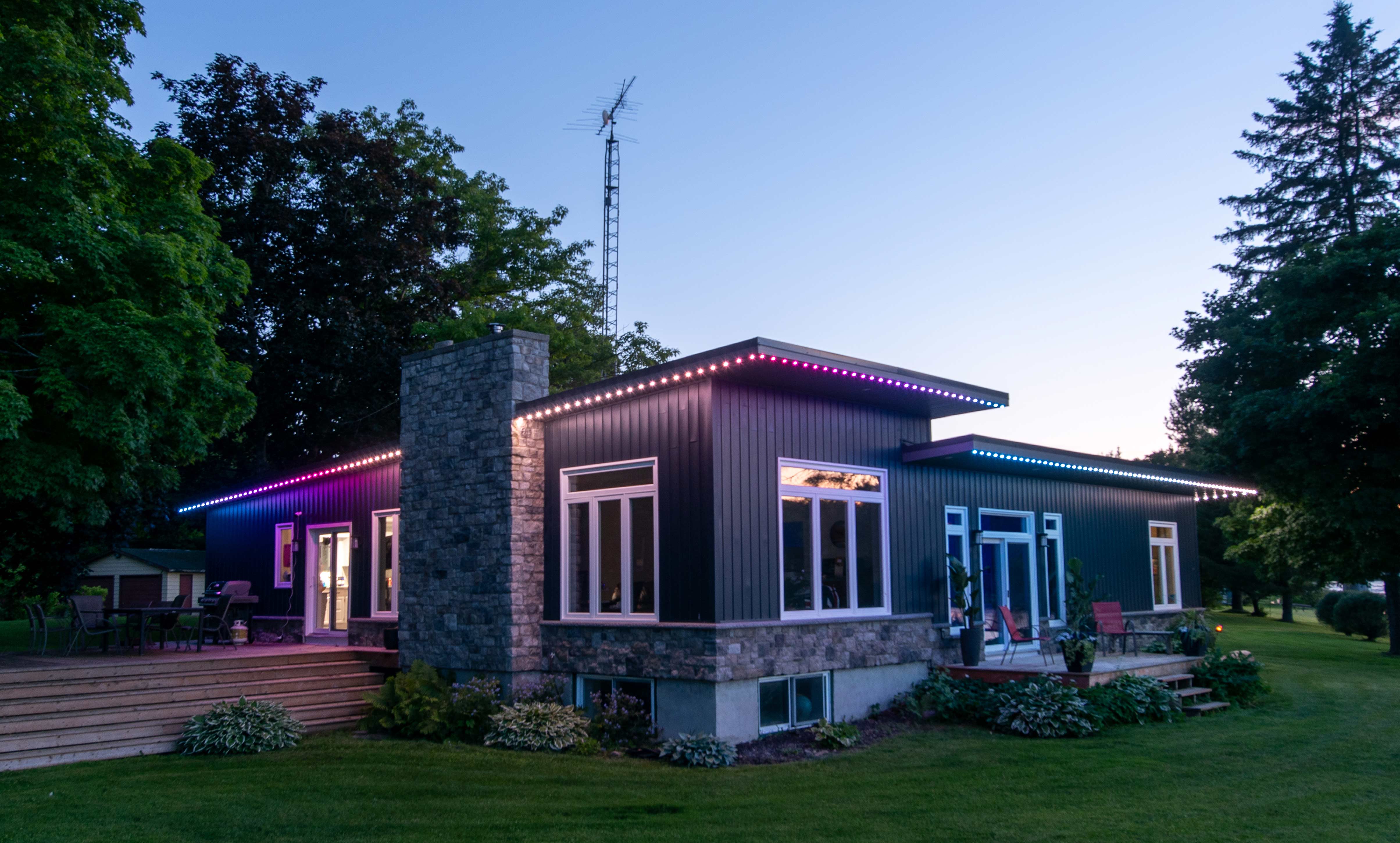 House with permanent holiday lighting installed along the roofline