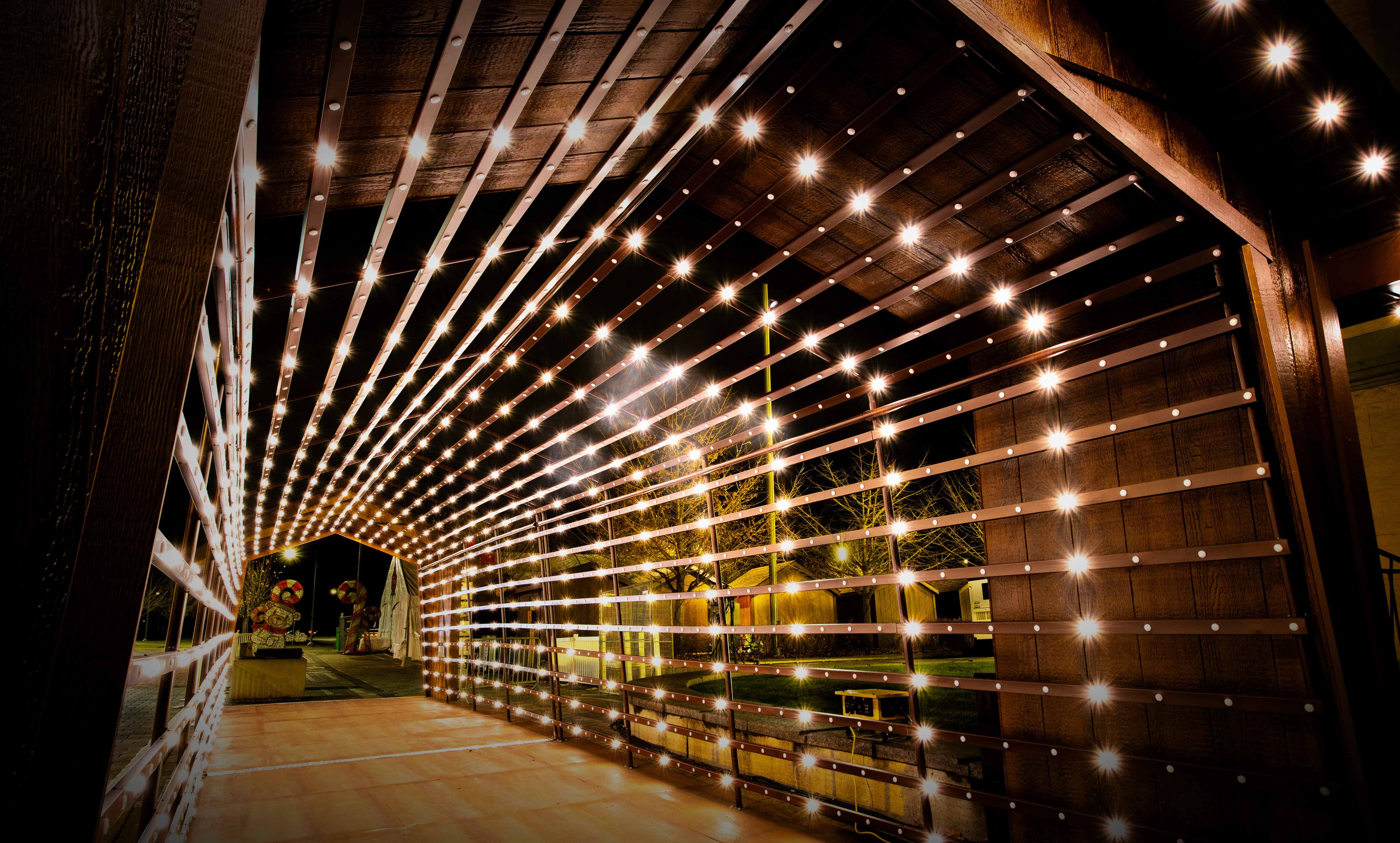 Twinkle Tunnel illuminated with Celebright permanent holiday lights creating a vibrant, glowing walkway